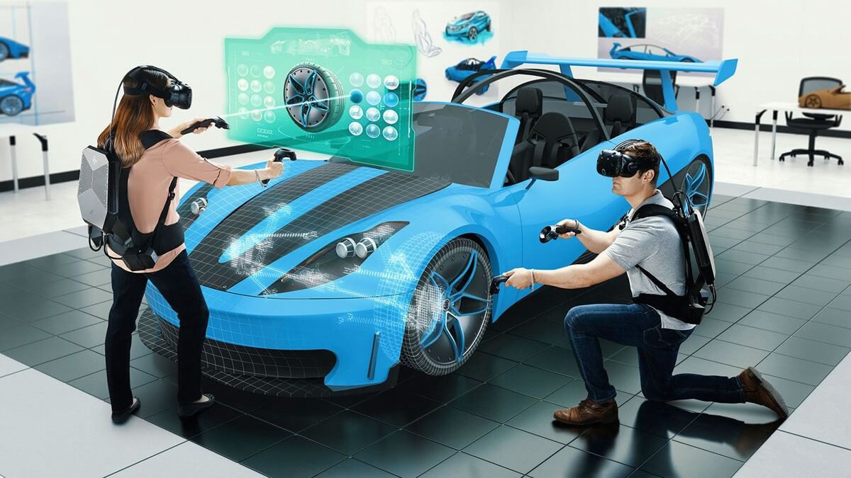 Two people wearing a VR headset and holding controllers working on a holographic car